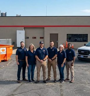 The Detroit Dumpster Co crew with the trucks