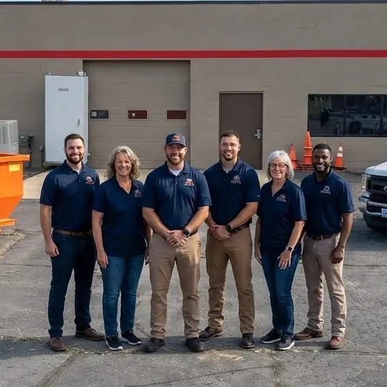 The Detroit Dumpster Co crew in front of the trucks